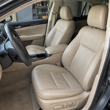Restored beige leather car seats and center armrest