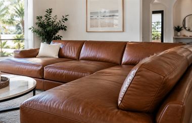 New cognac leather sectional in a bright home